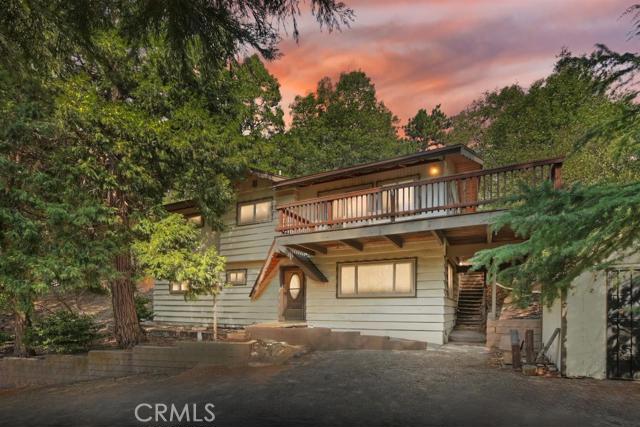 Lake Gregory is a short walk away from this San Moritz area home in Crestline. Located one street back from the lake is this well maintained home. Pull right up to the front door, parking for several cars. Enter into the den/bonus room. One bedroom and 3/4 bath on this level along with laundry and storage area. Upstairs is the Great room with vaulted, tongue and groove ceilings, fireplace and lots of light and open space. Large kitchen with plenty of counter space and storage. Three bedrooms on this level with full bathroom and half bathroom in one. Home has partial wrap around deck, new carpet, newly painted on the interior, dual pane windows, dog run in back and shed area. Great location in town.