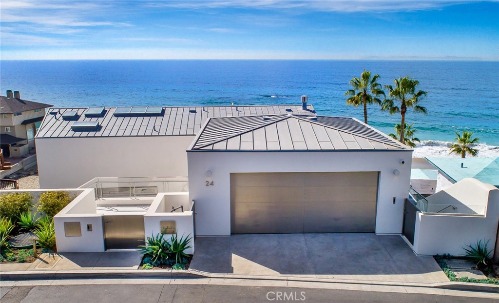 Stunning oceanfront Modern enjoys a coveted spot on the pristine sands of Lagunita, a gated community just a stone’s throw from the famed Montage Resort. The final masterpiece of renowned LA-based architect Stephen Kanner, this home showcases impeccable design along with a lengthy list of luxe amenities and creature comforts. Complete with four bedrooms, all en suite bathroom—it's nearly 6,000 square-foot interior is defined by polished white Terrazzo flooring, dramatic high ceilings that make it feel all the more spacious, and floor-to-ceiling walls of glass, custom-made by Victrosca —the latter of which gracefully glide open to bring the outdoors in, making the property’s prime views of the crashing waves even more prominent. Walk out to the home’s exterior grounds spanning almost 3,000 square feet and experience an ocean-view courtyard, a full outdoor kitchen, mosaic infinity pool with a waterfall, lawn and beach gate.