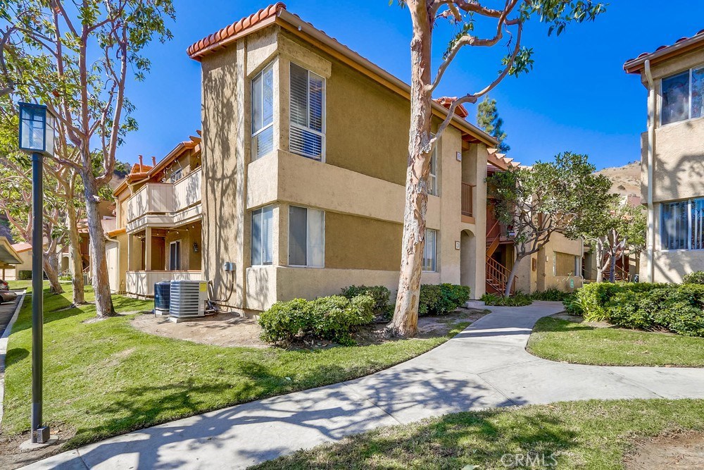 Welcome to The Hills Community of Yorba Linda. This unit is a corner lower level unit with 2 bedroom 2 bathroom and 1252 sq. ft. of living space. Beautiful wood laminate floors throughout and newer carpet in the bedrooms recently replaced. The floorplan is open and airy, the remodeled kitchen
has tons of added cabinet space and is upgraded with granite counter tops, range, built-in microwave, and a dishwasher. The spacious master bedroom is ensuite and includes a large walk-in closet. The secondary bath has been remodeled. You have total access to the wrap around patio through the family/living room or kitchen! The dedicated Laundry room is in it's own room at the far end of the patio. Amenities at The Hills Community include tennis courts, exercise room, clubhouse, 2 playgrounds,2 pools, and 3 spas. Close to shopping centers, restaurants, schools and freeways!! Comes with visitor parking and 2 dedicated covered parking spaces (449 and 450). Right outside the unit for added convenience.