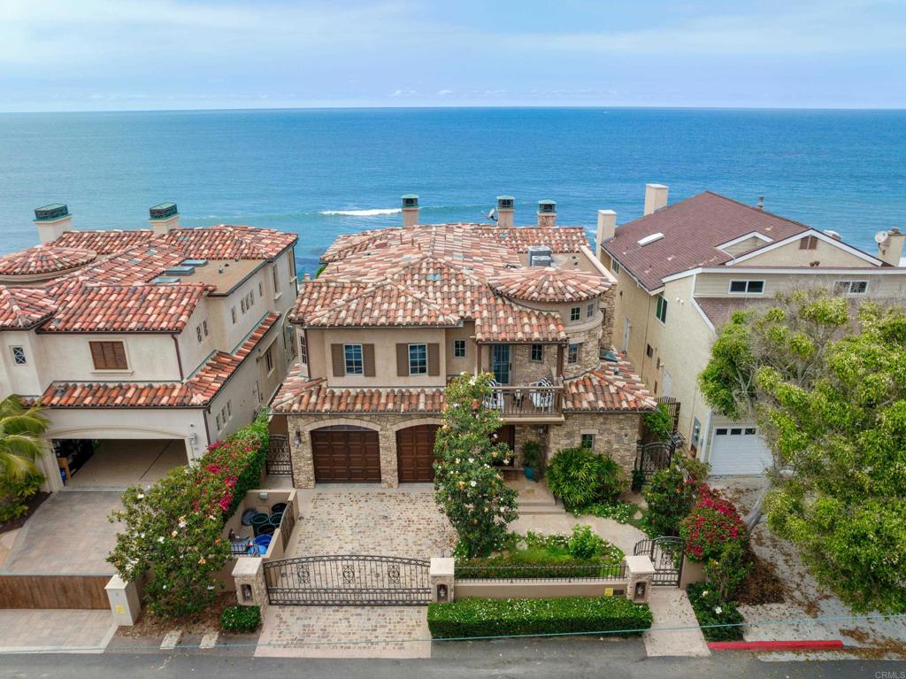 Built from the ground up in 2016 with one of the largest oceanfront backyards in Encinitas with upper and lower sea wall framed in steel and concrete, 828 Neptune is not only a beautiful Tuscan estate perched atop one of the most magnificent strips of California coastline, it is one of the best constructed oceanfront sites in all of Encinitas. This 3 story, home features a custom wrought iron spiral staircase with a statement 27 foot Bocci glass chandelier, solid walnut plank flooring, Soffit ceilings, Venetian plaster wall finish with crown molding throughout, home theatre perfect for entertaining and frameless glass doors looking out to unobstructed Pacific Ocean views! The kitchen was designed by world-renowned Kitchen Expo - Rich Famie fully equipped with Wolf appliances, cherrywood cabinets, Phylrich & Hansgrohe oil rubbed bronze plumbing fixtures and Madagascar stone countertops with natural curves inspired by those of the ocean. The primary retreat is situated on the top floor overlooking the ocean with a spa-like primary bath featuring heated floors, towel heaters, a steam shower, jetted tub and sauna. From the atmospheric variable color change lighting throughout to the elevator with changing mosaic art on each floor (designed by Rick Sakalic); this home is not only a work of art but also inspired by the majestic beauty of its natural coastal surroundings with modern luxury conveniences. The home has a full home automation system to manage lighting, security, surveillance, audio/visual and window shades and a 3 car garage with a lift. This property is truly one of a kind in a prime location offering a lifestyle that is coveted by most but attained by few.