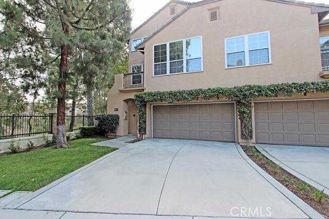 Best loft unit location in The Summit! This meticulously maintained end of cul-de-sac unit boasts a beautiful view of the woods, as well as a rare 2 car driveway for additional legal parking, making this the best loft unit in this serene gated Newport Coast community. The ideal open floor plan includes 2 bedrooms, 3 bathrooms, and a large loft. New carpet and laminate wood flooring have been installed and the walls have been freshly painted throughout the home. The high ceilings give a touch of elegance and a more open and bright feeling to the living room and dining room. The master bedroom has a spacious walk-in closet, dual sink, and a private balcony. There are built in cabinets for extra storage space in the attached 2 car garage, and an additional large storage area in loft. The community offers a pool, spa, greenbelts, playground and biking and walking paths. Close proximity to downtown Corona del Mar, Crystal Cove State Park, beautiful beaches and popular shopping centers such as Fashion Island and Crystal Cove. Truly a one of a kind opportunity you do not want to miss!