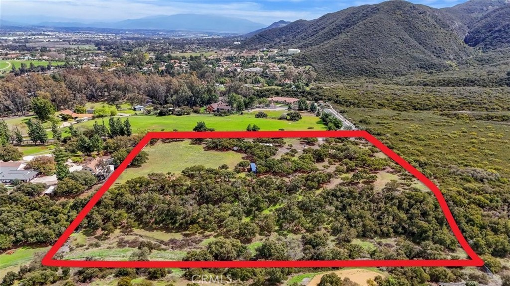 **Price Improvement** This meticulously maintained 5.45 acre parcel in west Murrieta presents an exceptional opportunity to build your dream home in an idyllic location. Let your imagination run wild with opportunity. From equestrian to agricultural, this property offers the space for almost anything. Offering breathtaking views of the valley & mountains that surround the property, you feel miles from civilization but in actuality are just minutes from all that the Temecula Valley has to offer. Conveniently situated less than five minutes from the freeway, shopping & dining. This property offers both privacy & accessibility and runs against the scenic hills of protected land, offering peace of mind. The flat gated parcel features pruned Oak trees, mountain & city views and is fully fenced! Rough connection to water & electricity already installed but non-operational until home is permitted. Too much land? Lot can be split! Full architectural plans available for a custom 4,000sf single-story residence & ADU, along with soils & biological reports, providing significant savings and streamlining the development process. With most preliminary work completed, including water & power on-site along with a successful Perc test, this property will save you years of planning. Don’t miss the chance to bring your vision to life in one of the most sought-after areas in the region. This turnkey site is ready for your next project. Award-winning Murrieta School District and NO HOA!