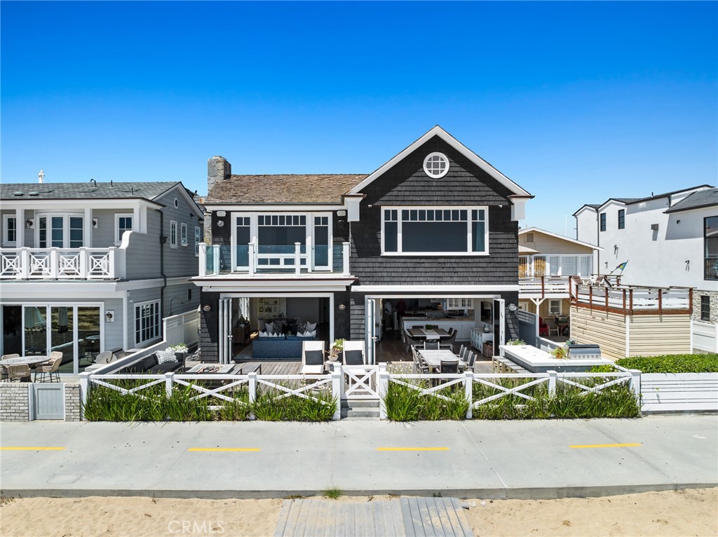 A timeless Hampton’s-inspired beach home set on an enviable 45' wide parcel along the Balboa Peninsula oceanfront strand. Light, bright and abundantly spacious interiors convey a sophisticated, beach-chic style that comes across as effortless and calming. The stunning open concept floor plan was designed specifically for friends and family to gather and enjoy the generously scaled indoor and outdoor living spaces. Walls of glass disappear opening onto an impressive outdoor living room, complete with a built-in barbeque/kitchen area, and cozy beach front fire pit. The oceanfront great room and adjoining dining area open to the professional-grade kitchen complimented by gleaming stainless-steel appliances, honed stone counters, custom lighting, a butcher-block service island, and walk-in pantry. The adjacent media room, powder bath, and laundry area complete the first-floor accommodations. The second level living spaces are thoughtfully considered with four generously proportioned bedroom suites. The sunny, welcoming environs of the primary suite provide panoramic coastline views from the world-famous Wedge to Catalina Island and spectacular over-water sunsets. Dramatic, vaulted ceilings, dual his and hers baths and dressing areas, and a connecting sitting room with an oceanfront terrace complete the primary retreat. A rare commodity at the beach, the home also boasts an oversized three car garage with attic storage above and three adjacent outdoor parking spots. An exceptional floor plan, conveyed with an on-point seaside aesthetic are the attributes of this classic Newport Beach oceanfront home. *Possible Seller Finance Option Potential For Qualified Buyer. Call For Details.