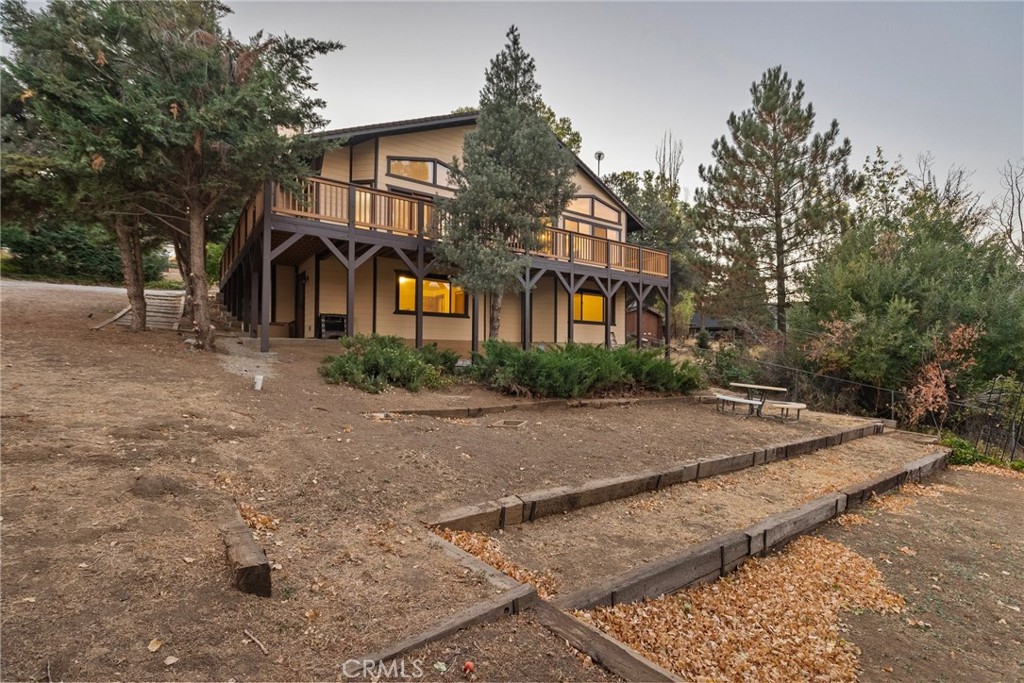 This four-bedroom, three-bathroom home nestled in Frazier Park features the perfect blend of rustic charm and modern comfort. Enjoy breathtaking mountain views from the spacious open-concept living area, complete with a wood-burning fireplace. The extra large kitchen, recently updated with brand new flooring, is ideal for family gatherings and entertaining. Upstairs, two bedrooms boast stunning vistas, while the lower level, close to an additional 600 sq ft, provides additional space and access to the backyard. The large upper deck, with newly installed composite deckboards is perfect for outdoor dining, games, and relaxation. Over $80,000 worth of updates have been added. Surrounded by nature and easily accessible via I-5, this property is a true mountain retreat for families seeking a peaceful and enjoyable getaway.