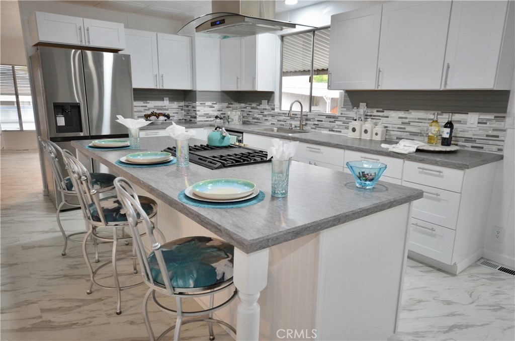 **PRICE IMPROVEMENT**Welcome to this stunning mobile home in the sought-after Sun City Mobile Estates, a 55+ community! This beautifully remodeled home offers all the comforts of a traditional house. Step inside and discover a move-in ready interior with a spacious open kitchen, perfect for relaxation and entertaining. The kitchen boasts new appliances, shaker cabinets, a stainless-steel sink, and new countertops. You'll love cooking on the brand new 5-burner stove, complete with a convenient griddle, all centered around a stylish island/bar area. Above, a stunning stainless steel and glass overhead vent provides both functionality and elegance. With 1440 square feet of living space, this home features two bedrooms, two bathrooms, and even an area designated for an office, providing ample room for comfortable living. Outside, you'll find low-maintenance rock landscaping and new concrete steps leading to the front porch, enhancing the home's curb appeal. Additionally, two storage sheds offer plenty of space for all your storage needs. The community itself is vibrant and active, offering amenities such as bingo, chair volleyball, card games, and holiday parties for residents to enjoy. Don't miss out on the opportunity to make this house your home and be a part of a wonderful lifestyle that awaits you in this welcoming community!