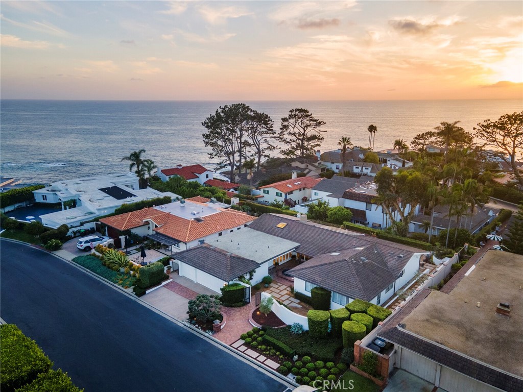 Live in one of the most sought-after gated communities in all of Southern California. This single-level, ocean-view home sitting on nearly a 1/4 acre lot in Monarch Bay offers the opportunity to add your touch on the existing home or design your dream property from the ground-up.
The home features no-interior steps, ocean views from the main living space, dining room and master bedroom, along with high ceilings and great natural light throughout. Four bedrooms and 2.5 bathrooms, 2 living spaces, a formal dining room and 3-car garage provide versatility. Take in the beautiful sunsets over the Pacific Ocean with both west and south facing views, or enjoy the resort lifestyle at your exclusive Monarch Bay Beach Club with full-service beach setups, fine dining, bar, firepits and entertainment.
This prime location enjoys the best of Orange County living with nearby five-star resorts like the Ritz Carlton, Waldorf-Astoria and the Montage Laguna Beach, easy access to spectacular beaches and tunning coastlines, the vibrant Lantern District with luxury restaurants and shopping, premier golf, a $500+ million renovation underway at Dana Point Harbor and a guard-gated community that currently enjoys no HOA payments and newly-completed amenities: sports court, pickleball and entrance, in addition to the aforementioned private and incomparable Monarch Bay Beach Club.