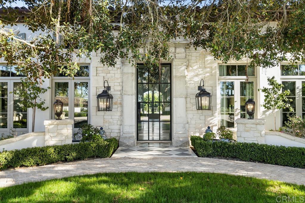 Previous sale at $18,000,000 included an additional small property. This sale represented only the main estate. One of the most beautiful estates in all of Rancho Santa Fe. This newer and spectacularly custom built one level estate is located on 3 all useable stunning manicured acres with scenic vistas. The floor plan provides an ideal living environment as public rooms open graciously to one another and the main home offers 6+ bedroom suites, executive office, exercise room, and bonus rooms accented by the most amazing finishes throughout. Walls of glass doors lead out to the incredible gardens and emerald green grass with floating sunning deck, outdoor kitchen with pizza oven and additional outdoor living room off the family room. The home was built around a massive specimen Ficus presenting a dream setting. The oversized stone entry frames the steel and glass entry door displaying breathtaking marble flooring made from reclaimed 100 year old antique white & antique gray Spanish marble. Oversized planks of French Oak wood grace the kitchen, family room, and bedroom floors. The bathrooms were inspired by the finest resorts in the world, and the closets were all finished with incredible craftsmanship in mill work. The Habersham cabinets are a staple throughout the home. While the property is incredibly private, secure, and serene, the location is ideal located only 2 homes above the entry to the Golf Club and just a few hundred yards walk into town. A dream come true estate.