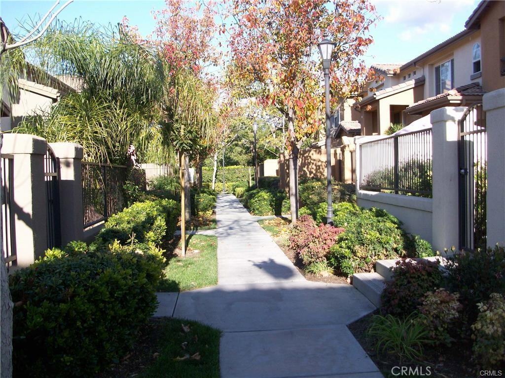 Very well located inside a private row of homes, this versatile and beautifully-appointed townhouse has a spacious front patio yard with lots of space to relax and enjoy a summer barbecue, or enjoy your own garden. Just repainted with lovely taupe interior paint, and brand new plush carpet installed. Ideally designed for roommates, there is a bedroom and full bath downstairs at the patio level, with the main master suite and living area located on the second level, offering the most possible privacy. Interior upgrades include gleaming Cherrywood and marble floors, granite kitchen counters and white plantation shutters. The big master bedroom has a bath suite with double sinks and a huge walk-in closet. The lower level has the second bedroom, a roomy area perfect as a space for a home office, a private laundry room and direct access to the 2-car attached garage. Located close to the popular Tustin Sportspark and just a 5-minute walk to public tennis courts, Homestead Park and the beautiful association pool complex with giant pool, relaxing spa, kiddy pool and barbecues, and very close to public walking trails, this wonderful home is also located in a very highly-rated school district: Myford Elementary, Pioneer Middle, and Beckman High.