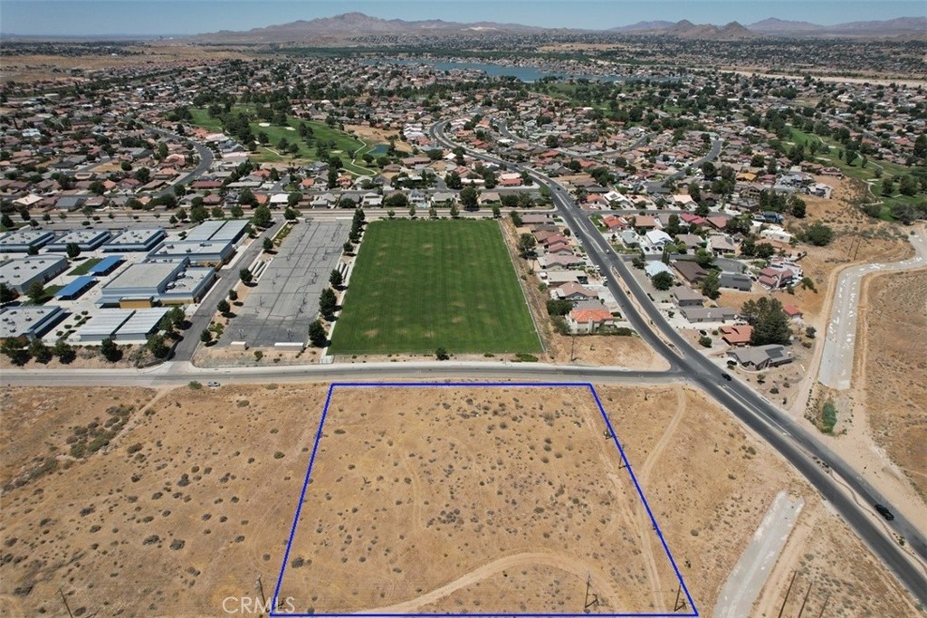 Magnificent elevated lot overlooking Spring Valley Lake Community. Land is zoned R2 which allows for a 20 unit apartment building. This property would be highly desirable for rental income from its proximity to Spring Valley Lake and Victor Valley College. Utilities are close to the subject property.