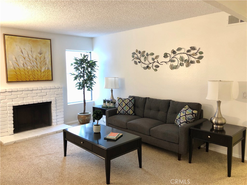Welcome to this ground level turnkey 2 bedroom/2 bath home in the sought after Cabrillo Park Community. The updated home is in mint move-in condition!! Everyone will love the open floor plan, the front patio and prime location near units reserved parking (and 1 guest/2nd car parking), guest parking area, complex pool/clubhouse/gym/spas. This home is within the boundaries of the coveted Tustin Unified School District including Foothill High. As you enter the front door you will love the open floor plan and the cozy fireplace in the living room.. Recent improvements include: updated kitchen cabinets and counters, new paint, ceiling fan in the dining area and new shower and tile in the master bath. Home is centrally located near shopping, eateries, coffee shops, public transportation, all major freeways and the downtown employment hub.