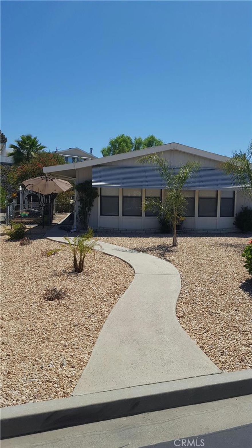 REAL NICE 2 BEDROOM 2 FULL BATH MANUFACTURED HOME WITH A FOUNDATION IN A GREAT SENIOR COMMUNITY   THE CLUBHOUSE HAS 2 SWIMMING POOLS AND AN INDOOR SPA  LARGE GROUNDS FOR COMMUNITY BAR B Q'S AND GATHERINGS  THE HOME FEATURES A LIVING ROOM AND A FAMILY ROOM  THE KITCHEN HAS A STOVE AND OVEN  A DISHWASHER AND A REFRIGERATOR  THE HOME IS ON THE GREENBELT IN THE REAR WITH A VIEW OF THE PARK   2 CAR COVERED PARKING AND NEW LOW WATER LANDSCAPING