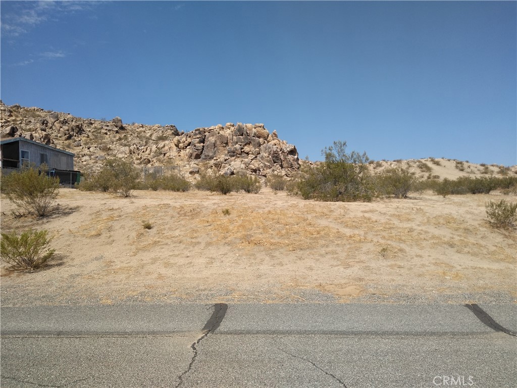 Commercial lot (C-RU) on main street of Lake Los Angeles, Adjoining lot also available. Electric & Water in the street. Buy one or both! Seller will consider financing with a minimum 60% down for a term not to exceed 36 months. *Buyer to make their own independent investigations regarding zoning & General Plan Designations, Hazard Zones, Availability & Costs of utilities.