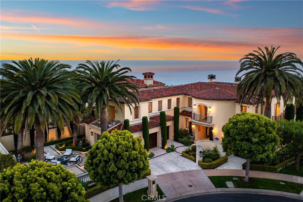 Indulge in coastal luxury at its finest with 16 Sail Vista in Newport Coast. This once in a lifetime custom estate sits at the top of the ultra-exclusive Pelican Crest community on a premier wraparound lot which features the best panoramic ocean and harbor views in the city. The breathtaking shoreline views with year round sunsets and Catalina rest in the back drop. Every inch of this architect-driven, open-concept home has been carefully curated with structure and entertainment in mind. Radiating an encapsulates luxury living at every turn. This exceptional architectural masterpiece offers 4 bedroom suites, an office or optional 5th guest room and an exquisite assortment of sophisticated design elements from the marble flooring, up to the custom designed chandeliers. The gourmet chef’s kitchen displays Calcutta gold marble countertops, walnut cabinetry, La Cornue French range with custom matching hood, twin clear Sub-Zero refrigerators with bottom freezers, a walk-in wet bar and a built-in Mielé coffee maker. Everything fusions with the fresh ocean breeze. The living room draws friends and family together, complete with custom built-ins, a stone fireplace, and an open floor plan that seamlessly connects indoor and outdoor areas which is perfect for entertaining. Outdoor pool and spa is not only hosting stylish celebrations and delighting esteemed guests, but also for peaceful, present living in a serene and sunset-drenched environment. The elegant master suite has its own getaway with a spacious living quarter, a custom fireplace mantle and dual master closets which rivals any modern-day luxury boutique. The hotel inspired primary bath features 'The Bridlington' from Penhaglion, in a skirted tub which creates a sense of luxury and elegance. Bi-fold doors lead you to your own private outdoor oasis which features a beautiful pool and spa and boast incredible sunrise & sunset ocean views. This enchanting palatial estate offers complete tranquility and is the pinnacle of Southern California coastal living that is built to elevate your lifestyle and must be experienced to truly appreciate it’s pristine and unparallel beauty.