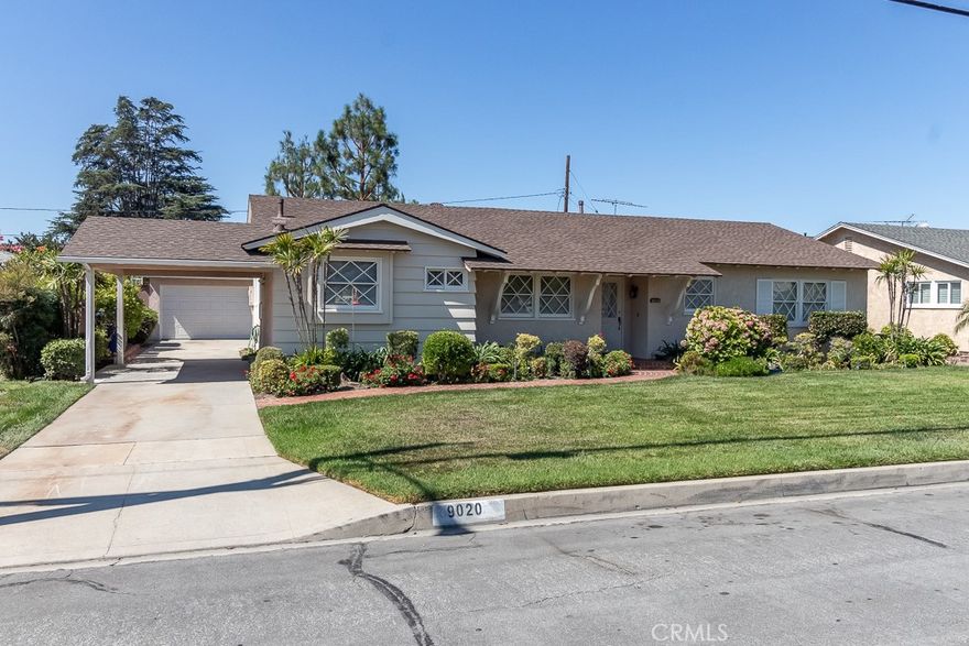 Come see this adorable, three bedroom, two bath, single story home in Downey! It has tons of curb appeal with it's crisscross front windows, winding brick walkway, and freshly painted outside. As you enter the clean, well-maintained home, the spacious living /dining room with it's striking wood/beam ceiling, and large brick fireplace welcomes you home. The kitchen has darling, original cabinets, room for a kitchen table, and is like stepping back in time. This home has great bones and is ready for your decorator touches to make it yours. There is direct access from the kitchen to the extra-long driveway with newer covered carport and two car detached garage with opener. The newer central air unit is energy efficient along with the double-pane windows throughout most of the home and the upgraded patio doors to go outside. The backyard is beautifully landscaped with an oversized, roof-covered patio to relax and gather with friends and family. Tons of memories will be made in this comfortable, fully landscaped yard. This is the one you have been waiting for.