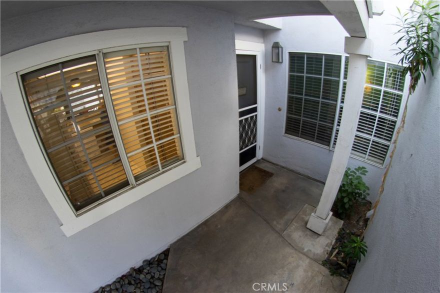 YOUR DREAM CONDO AWAITS YOU! This 2 bedroom condominium offers everything a buyer is looking for! Amazing Master bedroom with a walk in closet and bathroom with separate vanity/sink area, large living room, spacious kitchen open to living room, Beautiful laminate wood flooring and tile  throughout home, washer and dryer hookups in garage, brand new A/C unit, and a cozy patio/yard for BBQ and entertaining. Also, with association pool steps away.  This condo is in  a wonderful location as it is close to shopping, schools, movie theaters, parks, golf courses and plenty more! Come see this wonderful condominium today and make it yours!