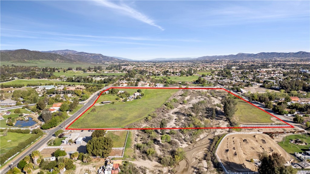 Great location near the down town area of Murrieta California on 33.75 acres of land. This is a beautiful piece of gentle sloping land. Great views from all around! Sellers have own the property for years. This is a once in a life time opportunity to own this type of large acreage. Includes one conventional built home with 3 bedrooms and 1 3/4 baths and a 2 car garage with approx. 1410 square feet (buyer to verify). And one triple wide manufactured home with 3 bedrooms and 2 bathrooms approx. 1920 square feet (buyer to verify) . Includes 2 wells. Property is fenced in certain areas of the property. Several other outbuilding for possible storage or horses? This property is a must see!