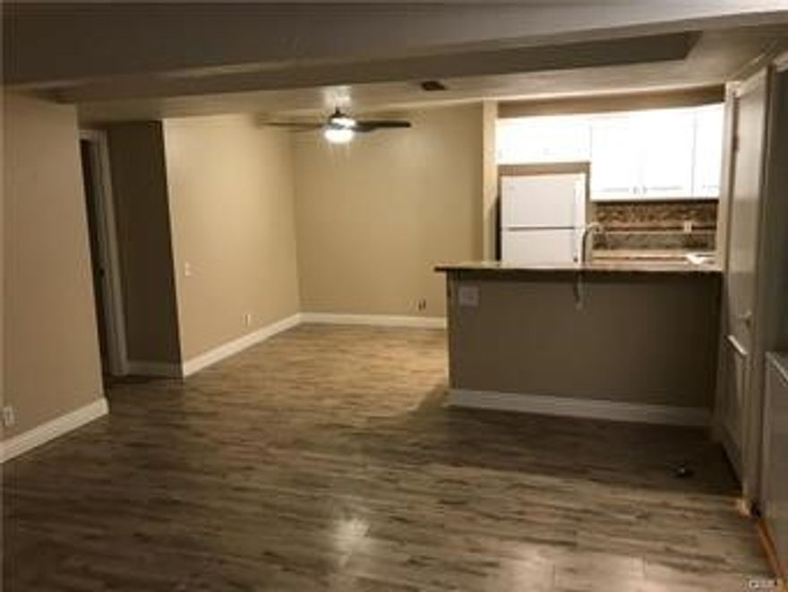 Fantastic location and  super cute lower level unit. Very open floor plan with a huge walk in closet. stackable washer and dryer. newer flooring, white kitchen cabinets with granite counter tops and designer backsplash, recessed lighting, new shower glass door, newer refrigerator, blinds, gated complex right near the tennis courts and the unit has a wonderful view of the city lights. This is a terrific condo.  Ideal location in the gated complex