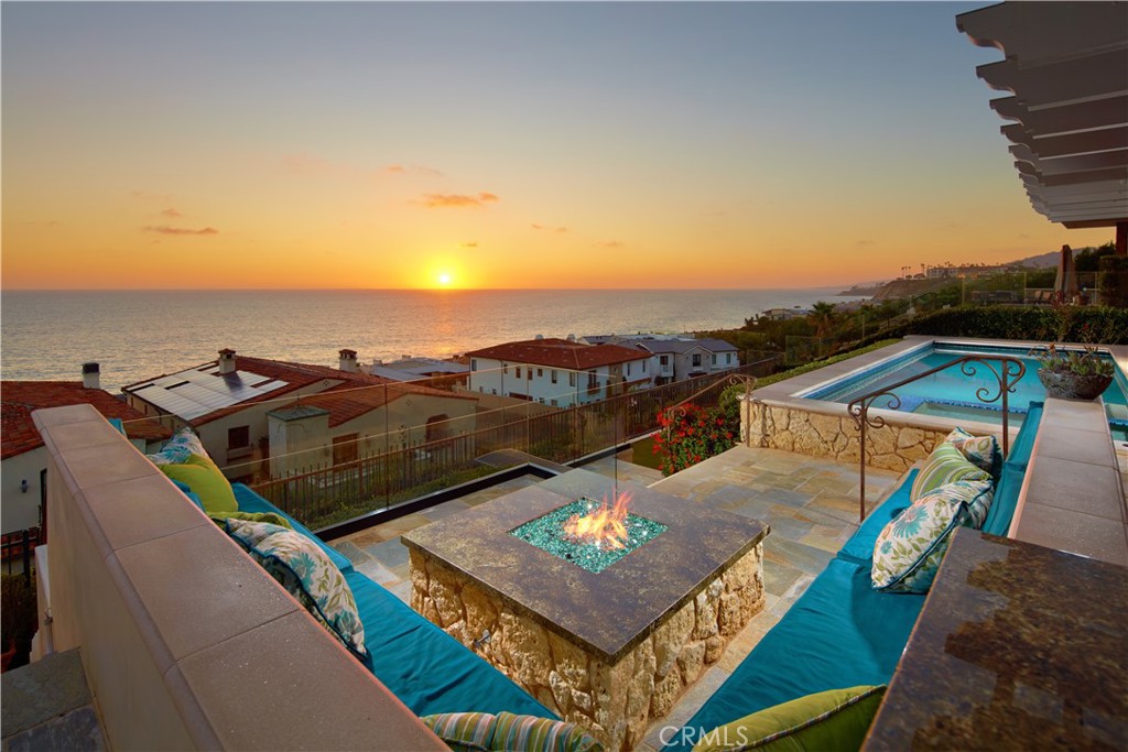 Spectacular whitewater views and Pacific Ocean panoramas are destined to embellish your lifestyle at this custom Santa Barbara-inspired home at Monarch Beach’s guard-gated The Strand at Headlands enclave in Dana Point. Enjoying the coveted lower Strand location, the luxurious residence reflects outstanding craftsmanship and enduring luxury throughout its nearly 6,307 square feet. Five bedrooms and four-and-two-half-baths provide private escapes for residents and guests alike, with the fifth bedroom offering the option of being used as a large bonus room with built-in cabinetry. Relax by the fire in your primary suite as waves crest and break on Strand Beach, take in the sublime views from the suite’s heated balcony, and pamper yourself in its spa-caliber bath. Powered by state-of-the-art solar panels, the home displays a formal foyer, stone and hardwood flooring throughout, high ceilings, custom lighting fixtures, a dramatic curved staircase, and formal living and dining rooms for firstclass entertaining. Share fun times in a generous family room that opens to a custom kitchen complete with a breakfast nook and Wolf and SubZero appliances. Extra storage and 2 EV chargers are featured in an attached three-car garage, the laundry room is located on the second level, and a handsome office is revealed on the main floor. Overlooking the ocean, coastline and colorful sunsets, the backyard takes outdoor enjoyment to impressive new heights. A heated loggia opens to a pool and spa, and further amenities include a BBQ with built-in seating, an open-air fireplace, a fountain and outdoor shower. The private cul-de-sac has the fewest number homes than any other single-loaded street in the community and is close to the Strand Beach funicular. The Strand amenities include a beach club, 70 acres of parks, and scenic trails. The Ritz-Carlton Resort, Dana Point Harbor, Laguna Beach, golf, top-tier schools and more are mere moments from home at The Strand.