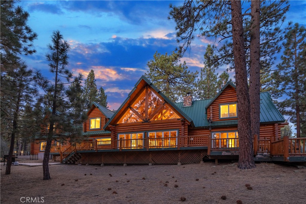 Absolutely amazing log home on a rare level acre + lot in the heart of Big Bear! Ideally positioned on the property to take in the forest setting from the back deck. Amazing interior offers soaring beamed ceilings with 2 story river rock fireplace, 3 huge bedrooms with a bonus 4th bedroom, game room with bar, large master bath for just a few of the highlights. New flooring and recently updated kitchen. Spacious outdoor decking w/ Spa that overlooks the forest to take in the setting & ideal for stargazing. This home is perfect for large gatherings or corporate retreats. 1000 sf 3 car garage with bedroom, in-ground well, metal roofing with new solar system and great income figures. Plenty of room on the property for endless possibilities tennis, pickle-ball court, RV garage or just keep it the way it is for your mountain oasis!