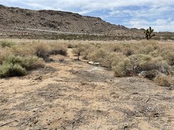 HUGE Price Reduction!! This is a GREAT lot to build on or for long term investment. Everything has been subdivided out and a nice 2.33 Acre flat site. The location is close to the 15 for commuting but far enough away to feel you have your own space. Seller will consider owner financing with 25% down.