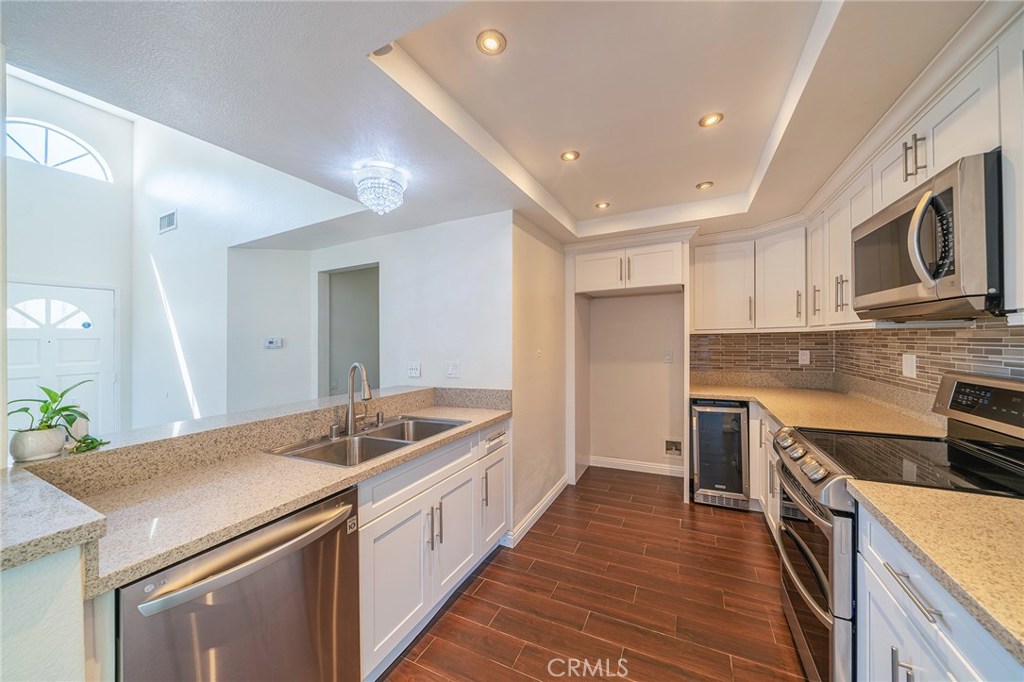 Stunning Townhome located in a very central location. This upper-level corner unit has beautiful views of the community. Recently remodeled kitchen with wine fridge, glass top electric cooking range, microwave, pantry and chandelier. The home has beautiful hardwood floors throughout the house. Spacious walk in closet in the master bedroom and deep closet in the secondary bedroom. This home is an ideal starter home for a family or for investment purpose. Low HOA and no Mello Roos. Close to school, parks, grocery, and restaurants.