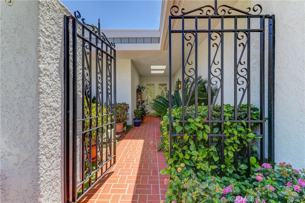 Gorgeously updated Casa Palma home located in the Exclusive "110" section of the sought-after community of Laguna Woods. Enter this property through a Private Entry gate into an extra-large Courtyard. Then enter the prestigious home through a custom double entry door into the center hallway. Enjoy the stoned gas fireplace and the custom 11-foot high shelving and cabinetry wall in the living room. The adjoining dining room features an exquisite chandelier. Step outside the beveled glass French doors from either of these rooms and Enjoy the Panoramic views from the large extended beautifully tiled patio. The kitchen has been upgraded with a large center island, skylight, recessed lighting, stainless steel appliances and a large dining area with an extra wall of cabinets. The master bedroom en suite features a double poled closet. The adjoining large master bathroom is outfitted with a double sink vanity and a large seated dressing table. The room features a glass blocked shower and a sunken tub overlooking an atrium view. The second bedroom featuring a large louvered door closet is currently being used as an office. A separate indoor laundry leads to an over-sized two car garage with loads of storage cabinets. The Village is located just 15 minutes from Laguna Beach and has many great amenities. Enjoy – 27 hole golf course. Separate executive golf course. Tennis courts. Seven clubhouses. Five swimming pools. Two fitness centers. 200+ clubs and much more.