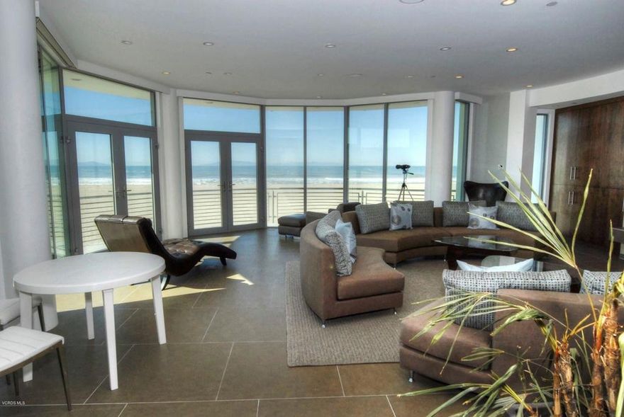 Contemporary custom beachfront home on semi-private street on widest frontage full ocean view lot. Two large sun swept entertainment decks on south side, one is adjacent to large den/entertainment area with sliding wall of glass when opened makes the inside become part of the outside. On 2nd level one deck is adjacent to open tv/bar/5th bedroom with grand 2nd level views. The house has 5 ocean view bedroom suites including a unique beachfront master bedroom with curved wall of glass and private balcony. Top quality throughout including large ocean view kitchen (open to den/entertainment area and adjacent to living room) with cooks island, beach view dining area, Viking stainless appliances and onyx countertops and backsplash. Also has steel and crystal staircase, 2nd floor catwalk, large 2 story media room with surround sound for big screen tv/film viewing. Rare corner lot = sweeping views of ocean, islands, whitewater, sunset, out over the Santa Barbara channel to the Channel Islands and Coastal foothills