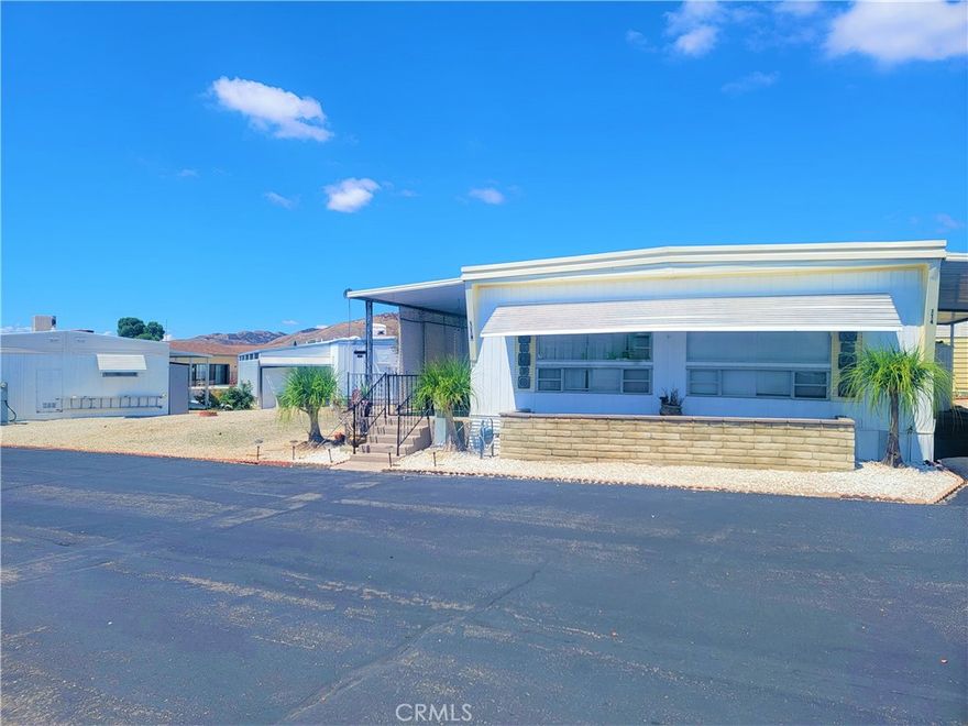 Cutie Patootie 2 bedroom 2 bathroom with bonus room on a larger lot In Crestview 55+ SENIOR PARK. This home sits on a big lot so you have no direct neighbor on your west side.  Open floor plan from living room to dining rooms. Updated kitchen and bathroom counters, newer laminated flooring and modern paint colors. Roof was resealed this year. Kitchen is light and bright with trendy white cabinets and dark gray laminate counters with the look of granite. The appliances stay, washer, dryer, refrigerator and free standing stove. Laundry area in kitchen. 1st bedroom is good size with updated paint, a skylight and a large closet. Guest Bathroom features updated laminate counters and a linen closet. Primary bedroom is extra large with attached bathroom. Bathroom area is divided by a half wall with dressing/make-up area with tons of storage. Massive walk in closet and separated shower and commode area. Enclosed patio room (8 x 18) with newer carpet and tons of windows off primary bedroom with access to the backyard.  Great covered front patio. Long carport with shed for extra storage. Walking distance to pool and clubhouse. Come see your new home today!!