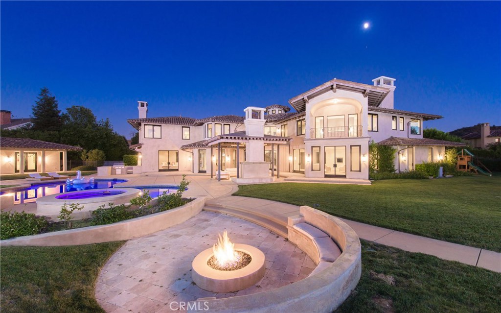 Modern Sophistication and Contemporary Styling are the groundwork for this ultra sexy Calabasas dream property behind the coveted gates at The Estates. Panoramic views from every perspective, this estate was recently reimagined in its entirety with designer finishes and and an open flow perfectly balancing function and composition. Custom glass doors surround the property and provide access to the impeccable grounds from nearly every room. A magnificent entry into a beautifully appointed circular staircase. A masterful kitchen complete with waterfall slabs, high quality custom cabinetry, designer built in appliances and a beautiful open flow to the family room, all over looking the grounds. There is a gorgeous theater seating for fourteen with state of the art audio and video. There are four bedrooms on the second level and one on the first level plus the guest house. There is a delightful private office set off a beautiful seating area with modern fireplace. The Master Suite is a personal penthouse, overlooking the panoramic views and grounds. A boutique walk in closet and incredible master spa bath. The grounds are invigorating. Mostly flat and at one acre, the expansive property features a stunning pool, spa, outdoor kitchen and entertainment under a covered structured with built in heat lamps and gorgeous fireplace and outdoor living room. This Estate finely tunes the best of all the Calabasas Luxury Life and balances modern day contemporary design and finishing.