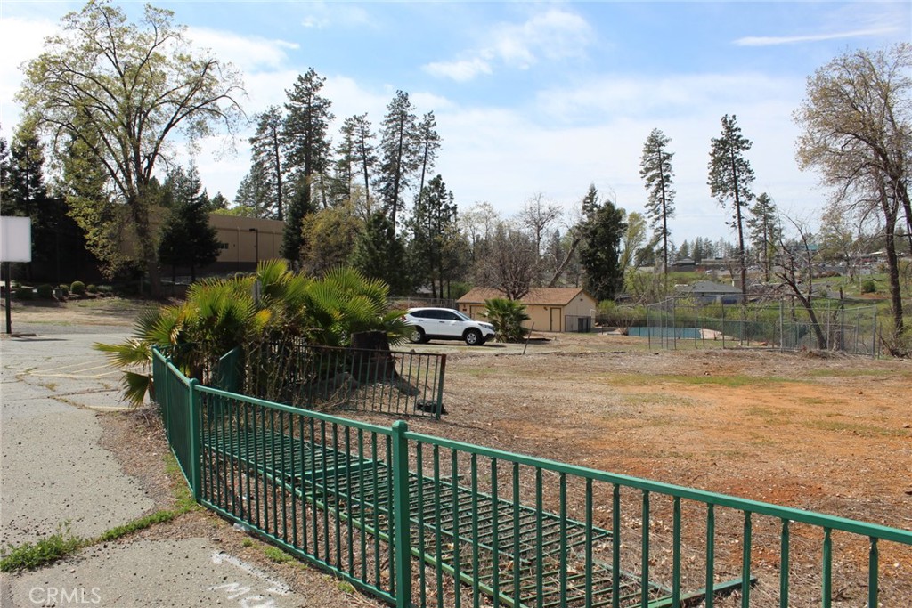 Here are two lots totaling 1.03 acre on one of the busiest roads in Paradise. Both are zoned CC, Community Commercial and being sold together. The larger lot is .63 of an acre, the smaller lot is apn 053-102-015 and .4 acre. The larger lot, prior to the fire held a family home, garage, swimming pool and a Restaurant on the front of the property with parking and signage. The over sized garage still remains in good condition and painted. It is not drywalled inside and windows are single pane. There is a small side room and some shelving. Parking lot is still in place and road entrances are in tact. Between the two lots, there is 214 feet of road frontage on Clark Rd. Absolutely fantastic visibility with easy in and out driveways on one of the two major business streets in town. Both properties are ready to serve with PID water and the smaller lot has a back flow devise installed. Utilities underground. In supplements, there is a feasibility study, and pool inspection. Buyers to do any and all inspections they deem necessary. Much more information can be found at the Building Resilience Center at 6295 Skyway. Act now!