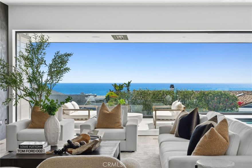 Newly updated & enhanced! Discover seaside excellence at this newly constructed modern masterpiece in the ultra-exclusive community of Cameo Shores. Designed by the acclaimed Geoff Sumich, this dream residence stands out with its breathtaking panoramas of the Pacific Ocean & Catalina Island, setting the stage for an extraordinary lifestyle across ~7,488sqft of sophisticated living spaces. The impressive architectural design and seamless indoor-outdoor flow is achieved through disappearing walls of glass in this open concept floor-plan, that offers a sense of single story living thanks to a main floor primary suite. The heart of the home showcases a luxurious ocean view that meets you immediately upon entry and carries through from the foyer, center courtyard with outdoor fireplace, jr primary suite, dining area, chefs kitchen, great room and deck with directly accessible pool + spa, giving residents the ultimate in resort style living. The primary suite is highlighted by sit-down views and dream-like sunsets through Fleetwood pocking doors and frameless corner viewing window. The suite is rounded out by a glass-framed fireplace, expansive dual walk-in closets, and lavish bath with a soaking tub & glass viewing window, perfectly positioned to literally bath in the ocean vistas. The custom estate features beautiful bespoke design elements and luxurious finishes, including a Cooritalia Italian facade, marble clad kitchen waterfall island with seating for 6, butler’s pantry/back kitchen, wine room, an office under vaulted ceilings, two en-suite guest bedrooms, designer powder room, and laundry. Descend via a commercial-grade elevator or the centerpiece staircase to the spacious subterranean level, a hub of entertainment with a bar, multimedia room, fully equipped gym with sauna, additional laundry, and walk-out backyard for dining al fresco against picturesque sunsets. An extra en-suite room provides versatile space for guests or family. Automobile aficionados will value the 2,000sqft+ showcase garage, featuring floor-to-ceiling glass to display and house up to 8 vehicles as captivating art pieces. Residents enjoy exclusive access to 3 private gated beaches and are moments from the vibrant Corona del Mar Village, Fashion Island, South Coast Plaza, and Pelican Hill Resort. With proximity to top schools, Crystal Cove, and John Wayne Airport, 4539 Fairfield Dr offers a life of unmatched luxury and convenience, where every day is a celebration of coastal grandeur.