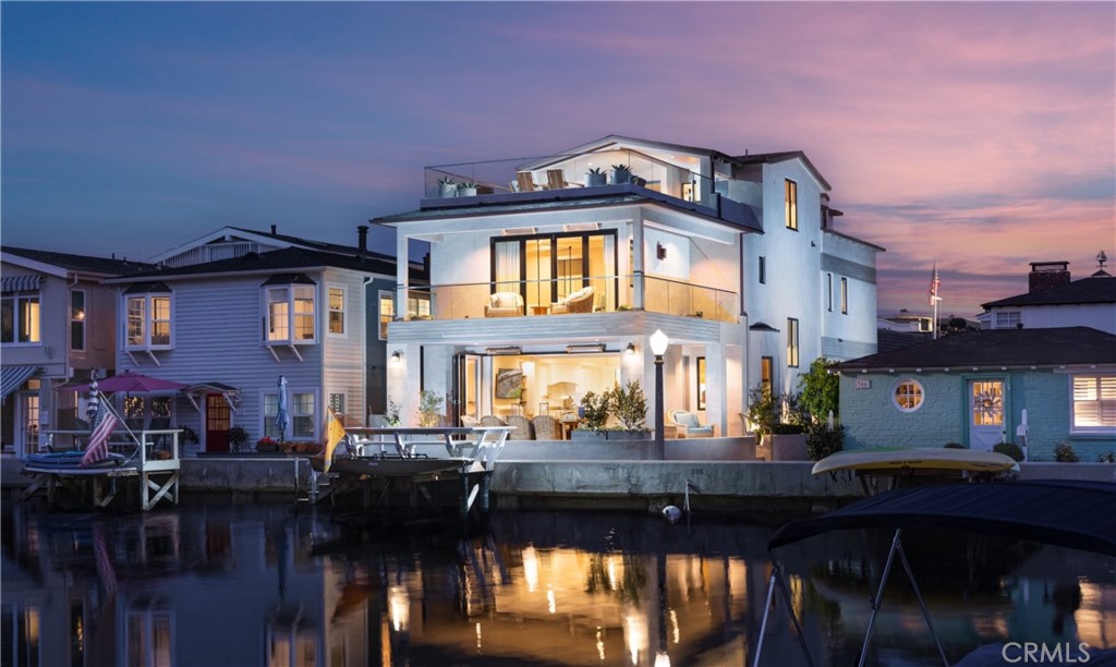 An exquisite Balboa Island residence poised to deliver the very best of Newport Beach living. Set within the coveted "Little Island," this pristine waterfront oasis offers 30’ of frontage and a private dock accommodating a vessel up to 18’. Swoon-worthy interiors by renowned designer Michael Smith span approximately 2,181 square feet over three levels and incorporate stylish touches such as hand-carved fireplace mantels, bespoke draperies, custom window treatments, wall coverings, and designer faucets/fixtures throughout. Anchored by a custom fireplace, the open-plan living area is accoutered with beamed ceilings, accordion glass doors, stone flooring, built-in shelving, and electric Lutron shades that open to reveal a soothing backdrop of the bay. Outside, entertain and dine al fresco in the heated covered patio made for year-round enjoyment. Tailored to modern tastes, the chef’s kitchen is dressed in stone countertops, subway tile backsplash, white shaker cabinetry, heated floors, and built-in Wolf and Sub-Zero appliances. Rounding out the main level is a breakfast nook, half bath, and 84-bottle wine room with storage racks. A curved wooden staircase rises to the second level where all three generously proportioned en suite bedrooms reside including the opulent fireplace-warmed primary suite equipped with two large walk-in California Closets, spa-like bath outfitted in marble, heated floors, discrete built-in refrigerator, and accordion glass doors that lead to a private wrap-around balcony with heated flooring. Crowning the home on the third floor is an exercise room with an en suite bath and an executive office featuring wood flooring and lighted, built-in display cases and cabinets. Beyond, the view roof deck is the idyllic entertainment venue with covered and uncovered spaces serviced by a kitchenette for easy hosting. Additional highlights include an ELEVATOR servicing all three levels, Control4 AV and lighting system, Hikvision security camera system, Electrolux washer/dryer, TOTO toilet/bidet, and two-car garage with built-in cabinets/storage. Set near picturesque beaches, shopping, dining, Lido House Hotel, and championship golf courses, in an exclusive waterfront community, the dream comes alive at 308 Grand Canal.