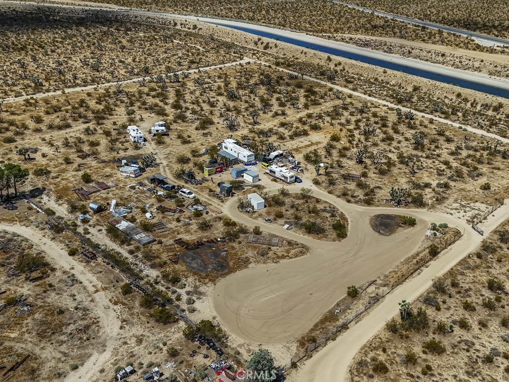 This property has it all. Water, location and Views! Water is supplied to the property by Baldy Water. Location! Did I say location. Easily accessible, only 1/4 mile off Hwy 138!!! Centrally located. Only 28 miles to HWY 395 in Victorville. And views ....... Enjoy spectacular sunsets and sunrises. See Mountains in the winter with snow. Centrally located. Only 28 miles from HWY 395 in Victorville. This property has a few personal items. All negotiable. Other items can remain on the property or may be removed per the buyer's preference. Do not wait to see this property.