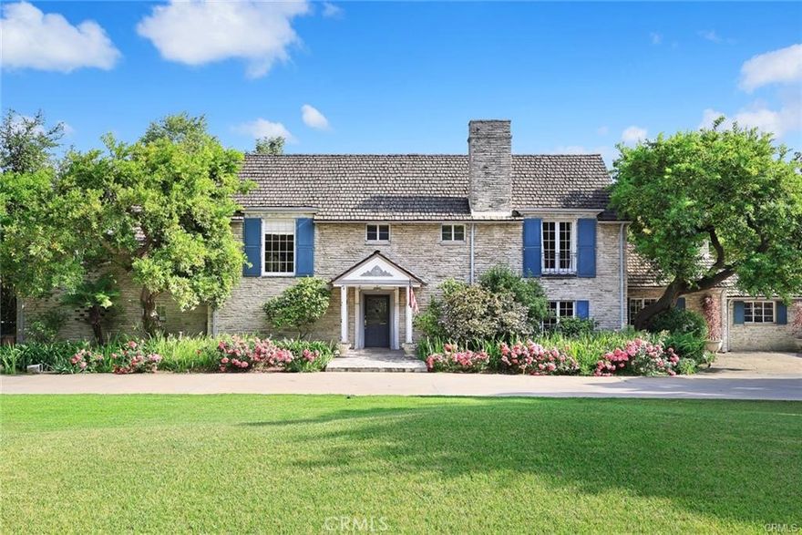 This magnificent English Country Manor estate locates in the center of the most coveted upper rancho area in the esteemed northern Arcadia. Standing on 2 parcels totaling over 1.5 acres, the stately home of 7,363 sq. ft. is completely encompassed by elaborate ornate wrought iron high fencing. The grand home features 5 bedrooms and 7 bathrooms with 2 ensuites on the first floor and 3 bedrooms and two bathrooms upstairs. The sophisticated floor plan flows from the gracious two-story foyer with an adjoining powder room and reading niche. The extravagant living room with a wet bar and the formal dining room both have beautiful marble fireplaces and hardwood floors and are lined by a slate walkway with French doors providing seamless indoor/outdoor flow of the lushness of the multiple rear patios full of grapes. A bright executive office with detailed wood paneling overlooks the rear gardens. An inviting gourmet kitchen with a center island, marble countertops, and delightful breakfast area has an adjoining butler’s pantry and an oversized laundry room, both lined with abundant cabinetry for storage. The light-filled family room with vaulted ceiling and fireplace makes an ideal gathering place for friends and family with its walls of French doors steps away from the enticing poolside pavilion perfect for outdoor entertaining. The luxurious primary bedroom retreat has two separate bathrooms, one on each side of the bedroom, with marble countertops, an oversized shower, and a relaxing soaking tub. French doors from the sitting area open to a rear patio and the primary suite is complete with two interior walk-in closets plus a gorgeous adjoining room-size custom closet fit for royalty. The expansive professionally landscaped grounds with bespoke designed gardens, sparkling pool and spa are a private enclave of splendor and are featured in the 2015 edition of Outstanding American Gardens portraying 50 of America's most beautiful gardens. A North/South tennis court is artfully tucked to the side of the large lot and has its own patio for watching tennis matches. This premier estate offers building your own masterpiece or making 2 separate houses, which has been approved by the city. This property is listed in Land as well. The MLS numer is WS24234755