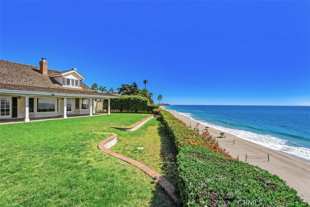 Discover an exceptional opportunity to own an oceanfront home nestled within the highly coveted 'Lost Winds' neighborhood of San Clemente. Revel in sweeping views of the Pacific Ocean stretching from Cotton's Point to Dana Point, with convenient beach access to Lausen’s just moments away. This custom-built 4-bedroom, 3.5-bathroom home boasts panoramic ocean vistas from nearly every room. The primary bedroom, thoughtfully situated on the first floor, opens onto an expansive patio and lush backyard, while an additional primary bedroom on the upper level offers equally stunning ocean panoramas. Meticulously designed, this residence features recent upgrades including a whole-house repipe, water filtration system, and tankless water heater. Original hardwood floors, vaulted ceilings with natural wood beams, and ample storage closets further the home's allure. Enhanced by a picturesque white picket fence, both the front and back yards offer enchanting spaces for relaxation and entertainment. With its captivating views and impeccable craftsmanship, this oceanfront oasis offers a lifestyle of unparalleled coastal luxury in the heart of San Clemente's most sought-after neighborhood.