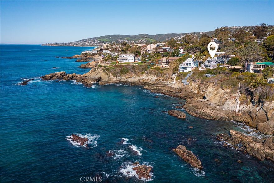 Set just south of Moss Point in South Laguna Bluffs, this custom compound affords breathtaking whitewater, ocean, Catalina, and sunset views from its desirable front-row location. The sound of waves breaking on the rocks below and the refreshing scent of sea breezes in the air enhance the ambiance of the residence, which is terraced on the bluff and embraced by sumptuously landscaped private grounds. A lush fern grotto leads to the main house welcoming fabulous ocean views from all three levels. Beyond a friendly Dutch entry door, the elegant yet casual design reveals an open-concept main level that complements entertaining with a fireplace-warmed living room, a dining room, a walk-in wet bar with copper sink and beverage refrigerator, and a spacious family room with built-ins and access to a refreshing ocean-view balcony. This level also presents a powder room, and chef’s kitchen with a butcher-block island, new white quartz countertops with full backsplash, white cabinetry, pantry, adjacent laundry room, and preferred appliances including a built-in cabinet-matched Sub-Zero refrigerator, Bosh dishwasher, and KitchenAid ovens. With a combined total of approximately 4,672 square feet, the main house includes three bedrooms and three-and-one-half-baths while the pool house hosts two bedrooms and one bath. The main house places one en suite bedroom on a lower floor that features a walk-in wine cellar, a wet bar, and an ocean-view great room. Outside, grounds at this level showcase a charming gazebo and a sunny deck with stairs leading to the rocks below. The primary suite, secondary bedroom, and second laundry room are located on the top level. A circular hall with skylight and inlaid wood medallion provides passage to a full bath,  secondary bedroom with a walk-in closet, and primary suite, which boasts stunning ocean views, cedar-lined walk-in closet, jetted soaking tub, and access to two balconies. The home’s bright and inviting pool house offers two more bedrooms, a bath, and living area with wet bar. A three-car garage and brick motor court await at street level. Furthering the allure of the estate are freshly painted interiors, new carpet, wood flooring, paneled walls and ceilings in varying locations, crown molding, wainscoting, custom tile work, and indoor-outdoor ceiling speakers.