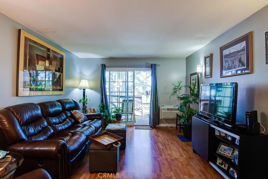 Gorgeous 2 bedroom 2 bath Seal Beach condo located in the highly sought after Rossmoor Park gated community. Award wining Los Alamitos schools. Spacious living room opens to a relaxing balcony over looking green landscape and trees. Beautiful Laminate floors throughout living area, kitchen and bedrooms, new tile in bathrooms. Large master bedroom has plenty of closet space and its own bathroom. Galley kitchen has new counter tops and oven hood and has a cozy breakfast nook that opens to balcony. New large window air conditioner, upgraded electric panel and new sliding glass doors are among  the many new upgrades. This unit is one of the few that has 2 subterranean parking spaces with storage for both. Rossmoor Park has 2 pools, Jacuzzi and gym, elevators and club house. Grounds are pet friendly and beautifully landscaped perfect place to call home. Close to parks, schools, shopping and convenient freeway access and minutes to the beach.