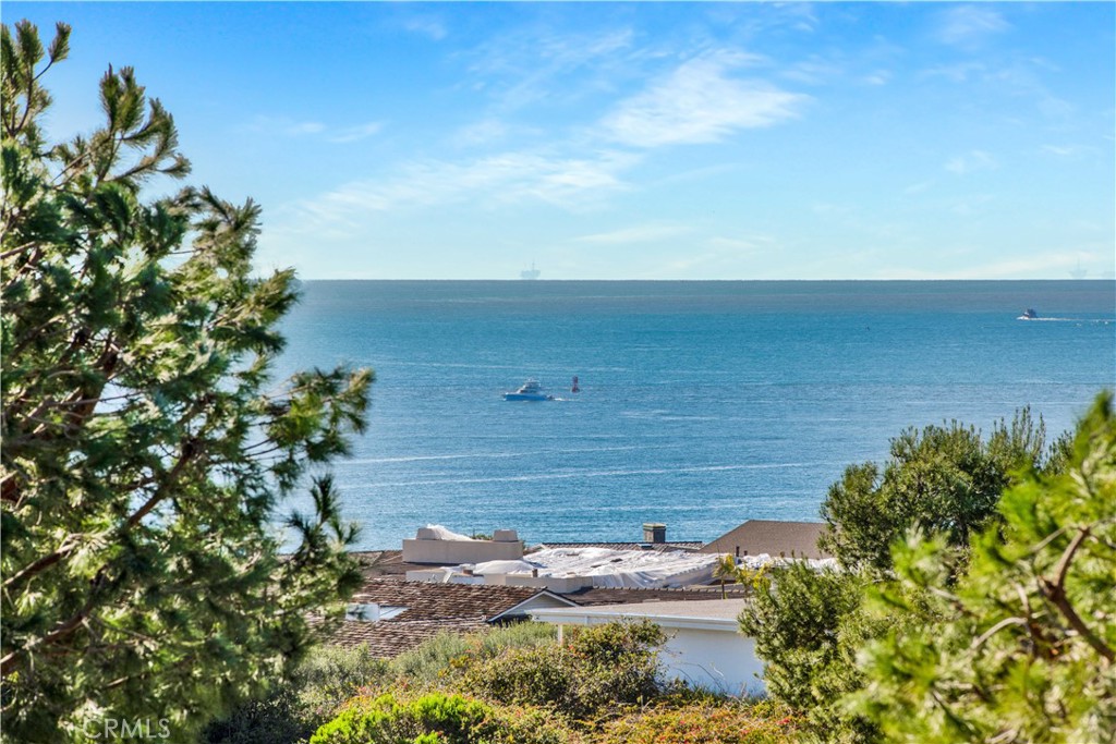Re-introducing 15 Shoreline: Unveiling the Pacific! Trees have been aggressively trimmed and now lovely Ocean Sunset views await! An iconic home with a storied history of renown. Designed by Newport Coast acclaimed architect Brion Jeanette, built by iconic Coastal Builder Tony Valentine and owned by a world renown philanthropic family, you're invited to create your own timeless story in this Modern Coastal Classic. This spectacular home has been meticulously transformed over the last year into a rare showcase of beauty & sophistication in iconic Newport Coast. Every inch of this home has been re-imagined to reflect an unparalleled level of refinement and effortlessly blends elegance with functionality. A premier location, tucked behind the gates of Pelican Point, an exclusive oceanfront enclave, covers almost 1/3 of an acre with private access through a backyard gate to Crystal Cove beach. This timeless vantage point provides an awe-inspiring backdrop for daily living, grand entertaining & offers a constant reminder of the beauty of the Pacific Ocean & world renowned Pelican Hills Golf Course. The unmatched quality of Designer selected finishes is endless: From Dolce Vita vanities to Calcatta glossy flooring to chevron style hardwood flooring. At the heart of this home lies the Chef’s kitchen, a culinary masterpiece adorned with the finest Signature Collection upgrades. Alluring Quartz counters on two prodigious islands and artisan crafted cabinetry complement the professional grade appliances. This impeccable kitchen not only caters to culinary enthusiasts, but also serves as a hub for entertaining and setting the stage to create lifelong memories. As you wake up, tap a button and the blinds will seamlessly disappear to reveal panoramic views of the ocean. Spark the enchantingly romantic fireplace, grab a cup of coffee from the en-suite niche and relax in the “view retreat” or the oversized view balcony. The Backyard is an entertainer’s dream, thoughtfully completed with multiple seating vignettes, outdoor kitchen, fireplace and pebble tech pool/spa. A true haven of relaxation with ample spaces to bask in luxury and a natural magnet for gatherings of friends & celebrations with family. An Incredible wine cellar with hand painted murals just down the spiral staircase is the ideal setting for celebrations at the end of a round. The abundantly landscaped grounds enhances the setting and adds the final touches of elegance to this striking modern coastal home.
