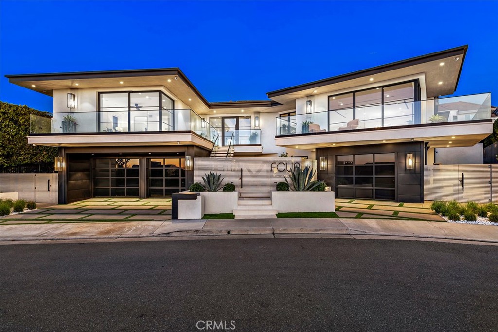 Luxurious ocean-view living, and five-star amenities converge in this remarkable newly constructed modern estate perched high in the guard gated community of Harbor Ridge. Over 7,000 +/- s.f. of living space, nearly 2,000 of which encompasses an open view great room, kitchen, and dining space – an entertainer’s dream and plenty of room for family, too. The chef’s kitchen showcases handcrafted custom cabinets, an oversized island with built-in 8-person banquette, large walk-in pantry, 60” Subzero, 3 dishwashers, 2 prep sinks, plus 2 Wolf warming drawers, steam oven, double oven, microwave, and built-in coffee system. The open living space has dual sliding pocket doors with a zero-post corner system that transforms the room to embrace a truly indoor-outdoor living experience overlooking expansive ocean, city, and Catalina views. The opposite side opens to the California Room with built-in ceiling heaters and a fireplace next to the resort-style pool. Unique for the neighborhood is a spacious rear yard with a grassy play area, an oversized built in BBQ island and a dining area under a modern 2-post pergola, perfect for relaxing and entertainment, all surrounded by elegant drought resistant landscaping. In all, this residence boasts 5 bedrooms and 7 bathrooms, to include dual primary suites, one on each level. The upstairs primary suite further showcases indoor-outdoor living with an additional zero post dual sliding pocket doors connected to a separate patio with expansive ocean and city views. The lower-level primary suite has a spa-bath with the finest marble, separate dual vanities, a ceiling fillable soaking tub, walk-in steam shower, and 2 massive dual walk-in closets. An 11-seat home theater with a 120” projector screen and built-in cabinets with wet bar is perfect for family movie night or to entertain guests. Constructed and designed for the builder himself, no expense was spared on the designer finishes, which include reclaimed wood, fine wallpaper, exquisite lighting and plumbing fixtures, French white oak wood flooring, and more. Additional amenities include a large laundry room with 2 washers and 2 dryers, garaging for 3 cars, Lutron Smart Home automation with electric shades throughout, whole house Savant music controls and speakers, a gym which doubles as a bullet-proof panic room, wine cellar, security camera system, mechanical room, wireless access points for total WIFI coverage and an elevator.