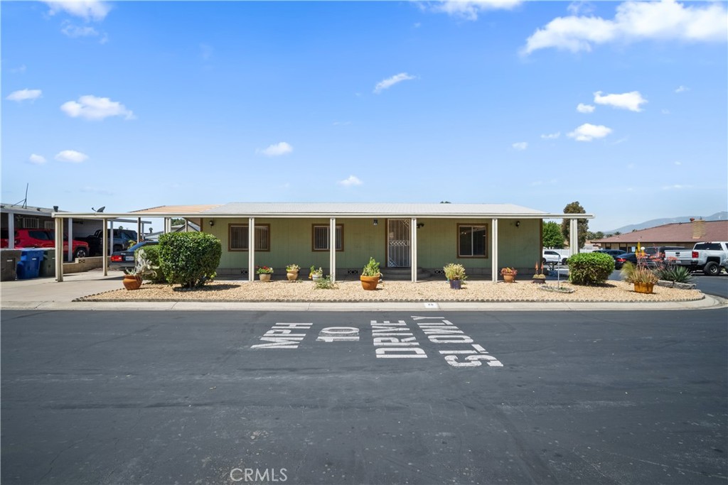BACK ON THE MARKET!! Welcome to Santiago Estates Mobile Park! Opportunity to own a well-maintained 2 bedroom/2 bath manufactured home with 1,152 sq ft on a spacious corner lot within walking distance to the community pool. Enjoy the spacious living room and separate dining area that flows easily into an amble size kitchen. Laundry room is conveniently located down the hallway with direct access to the rear covered patio area. Hall bedroom features carpet flooring, large closet and ceiling fan. At the end of the hallway, you will enter the primary bedroom that boast vaulted ceilings, large walk-in closet and ensuite bathroom for privacy. The exterior includes a covered carport for 2 vehicles with space for a 3rd vehicle on the side (uncovered). This home is conveniently located near the 91, 60 & 215 freeways, UCR, local schools, restaurants, medical centers, and shopping centers. ALL AGES ARE WELCOME! Pet friendly. Manufactured Home SOLD AS-IS. COMMUNITY AMENITIES INCLUDE: Laundry area, community club with kitchen, pool and spa.
