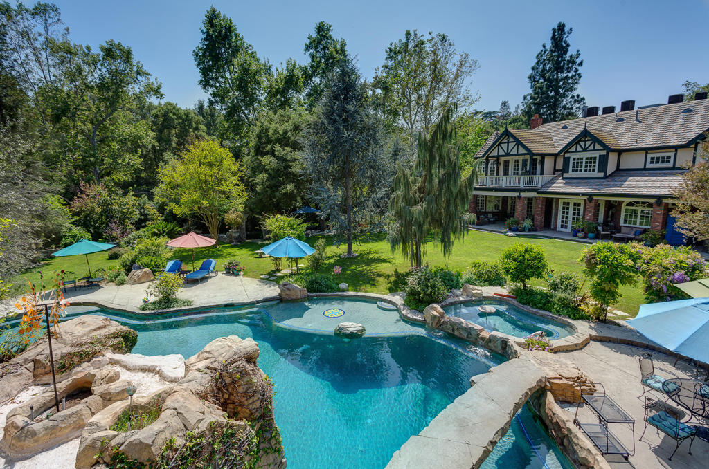 One of the most desirable locations in La Canada Flintridge! This custom estate was completed in 1995 Built for the current owners with amazing quality and workmanship throughout. The estate has whopping 10,000 sq.ft. of living space on a very private all flat lot. The resort style backyard is complete with a waterfall pool and slide and a private man-made grotto under the waterfalls. The master suite boasts a large sitting area and fireplace and a balcony that overlooks the beautiful lush landscapes of this magnificent estates gardens.