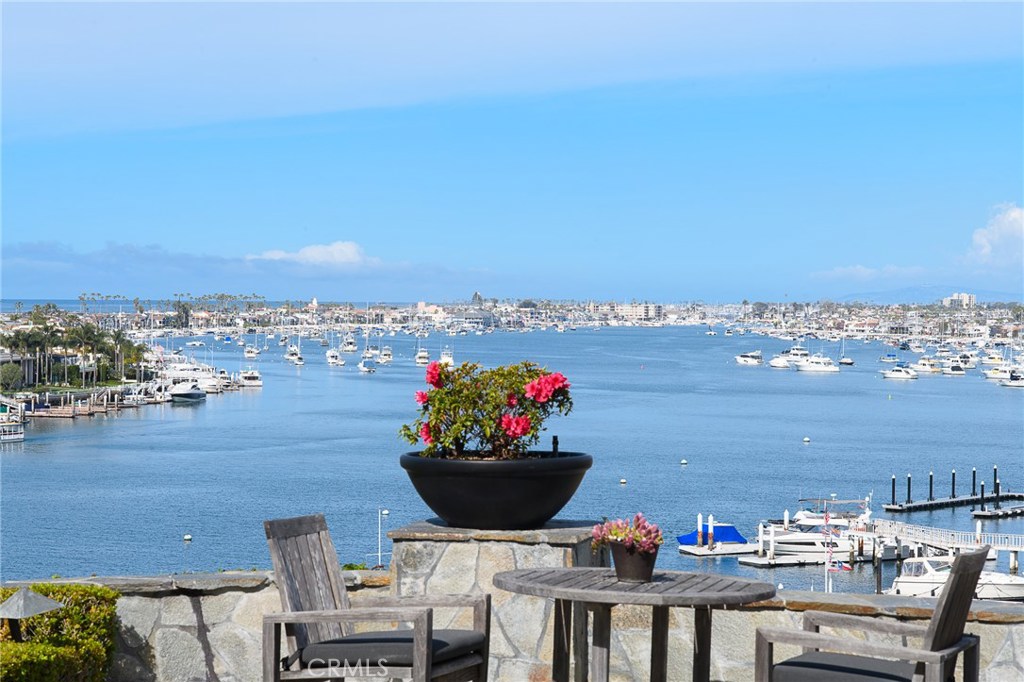 This incredible Corona del Mar residence impresses at every turn with stunning ocean, harbor and city light views providing a priceless backdrop for sophisticated entertaining and stylish living. Reflecting the talents of architect Horst Noppenberger, Aria Design and Prestige Builders, the contemporary home showcases indoor and outdoor living spaces that display striking fireplaces, slide-away walls of glass, and only the finest finishes and appointments including dark-stained white rift-oak flooring, travertine, indirect soffit lighting, and state-of-the art whole-house audio, video, and automation systems. Featured in Interiors Magazine and other respected publications, the chic custom design features a floating oak staircase, library, an approximate 54" pivoting mahogany entry door, grand foyer with 2-story ceiling, and glass enclosed office with spectacular ocean and harbor views. The alluring kitchen reveals dark oak Boffi Italian cabinetry, a travertine slab island, heated travertine flooring, stainless steel countertops, and top-of-the-line appliances. Two bedrooms complete the residence including the master suite with awe-inspiring views, a floor-to-ceiling glass wall to foyer, steel-faced gas fireplace, ceiling concealed tv, and custom oak Poliform Italian closet system. Situated on a low-traffic cul-de-sac in the Village near shopping, restaurants, Big Corona Beach, and entertainment, this sleek custom home is a cut above the rest.