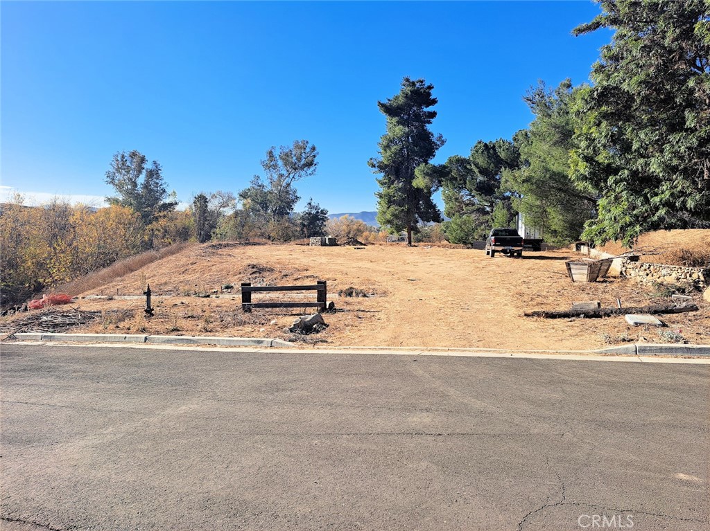 Here's a great opportunity to own a very private and serene, tree-lined 1.27-acre lot located in the center of Murrieta. This area is surrounded by
existing housing developments, semi-custom homes and custom homes. The property can accommodate a 4000+s.f. home, plus a shop on the
lower lot. A seasonal creek meanders on one edge of the property. Easy, paved access that's just minutes to shopping and the 15 & 215 freeways.
Municipal electric, water and sewer are stubbed to the property. As a plus, this property has its own water well. Update 1/2025.. .the secondary
emergency access road is in the final phase of approval with the city of Murrieta, so vacant lots in this area can soon be built on. Approval is expected to be completed before the time it takes for anyone to obtain a building permit from the city.