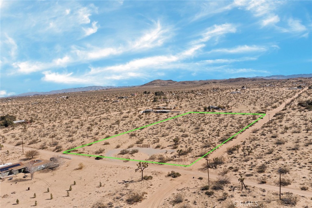 LOWEST PRICED COMMERCIALLY ZONED LOT IN LANDERS! Only a very small percentage of lots in Landers are zoned HV/RC (Homestead Valley, Rural Commercial). This 5 acre lot is one of those few. It's ready for you to create your 5 acre dream location! With the future growth of Landers a certainty, this rare commercial property will only continue to grow in value and importance to the community. If you're an artist, builder or maker, you can build a barndominium and have a live/work business space. Build a shop or other service business. Or just build your dream home, knowing that the commercial zoning will continue to grow your properties value over the coming years. The lot has decorative fences installed on the North side of the property and a gravel, circular driveway that allows your to pull up and park on the lot. Only 15-20% of the lot has been cleared for open space, leaving the remaining space in it's native, natural state. The property has many beautiful large joshua trees but not so many that it would require expensive removal and replanting to build. Water in street. Just North of the Post Office, Moose Lodge and Belfield Hall, it is central to all of Landers. Buyer do to own investigations concerning zoning and possible land uses for this property.