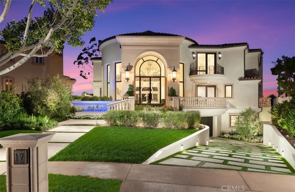 Nestled behind the exclusive gates of Pelican Ridge Estates, 17 Telescope boasts a private lot with dramatic ocean and coastline views. The custom estate has been newly redesigned offering a near stud down renovation with designer transitional finishes. The ~5,916 sqft. 5 bed + 6 bath home invites residents and guests alike with a grand interior with an impressive two-story foyer, spiral floating staircase, and catwalk which accentuate the breathtaking coastline views. The newly designed property offers bespoke finishes such as glass and iron front door, pre-cast clad exterior, French limestone and French oak floors, slab stone kitchen waterfall island & backsplash, gourmet chef's kitchen with Meile appliances, 8 car “dream” garage wrapped in custom Cleaf cabinetry including commercial grade refrigerator/freezer, custom ventilation & designer lighting throughout, and whole house automation. The true open concept floor-plan is complimented by a transitional, bright living space on the first floor, made possible by 20 foot soaring ceilings which deliver a sense of occasion; the remainder of the home provides seamless transitions between the living room, family room, gourmet kitchen, and outdoor entertainer’s dream backyard complete with resort style pool and sit down coastline and city light views. The main-floor bedroom provides an ideal retreat for guests, while 4 ensuite bedrooms upstairs, including a luxuriously appointed master suite with exceptional panoramic ocean views, highlight the upper level. The custom estate is rounded out by a rare 2,400 sq. foot 8 car “dream garage” along with immediate proximity to Pelican Hill Resort and their championship golf courses, Crystal Cove Beaches, Orange County’s premier shopping, award winning schools, and resort-style beaches.