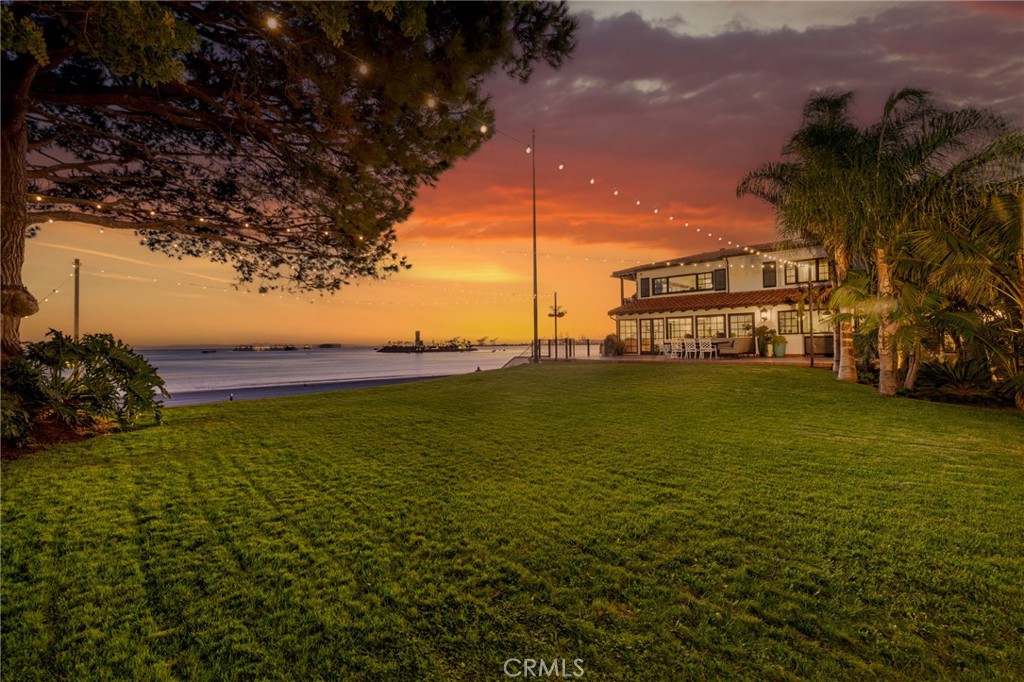 One of the last preserved estate properties sited directly on the sand of the Southern
California coastline. Nearly 1.3 acres of elevated land, protected from main streets and
bordered by two private, gated roads – this sprawling respite, surrounded by walled
gardens and a mature arboreal curtain is a true haven unfolding only to a 226-foot
panorama of wide sandy beaches along with sparkling ocean, evening-lights, and
sunset views. The spectacular residence, one of the largest and most refined in this
famed enclave’s collection of architecturally significant homes, is a sight to behold. Built
originally in 1926, the grounds and blueprint encapsulate idyllic seaside living with the
scale and accommodations of a bygone era. Completely renovated in 2022, the home
was redesigned to incorporate the requisite elements for elegant, modern living – while
maintaining the level of architectural detail rarely executed today. Encompassing over
7,600 square feet of living space, the interior presents a symphony of visually
captivating experiences. Every consideration was made in creating exceptionally stylish
– yet livable formal and informal areas finished with complementary appointments.
Precision craftsmanship; an incomparable assemblage of imported stones and
hardwoods; uncommonly sourced materials; bespoke furnishings and textiles; designer
lighting, fixtures, hardware, and wall coverings; artisan-crafted millwork, finish carpentry,
and ceiling details; the finest culinary and bath amenities; advanced technological
conveniences; along with a curated selection of antiquities and commissioned murals
tastefully grace every turn. Ensconced by mature trees and specimen plantings, the
expansive outdoor surround affords myriad environments for splendid experiences in
the natural setting. A glittering, swimming pool, spa, with an adjacent dedicated bath
and pool deck; two interior courtyards; a reflecting pool with over 50 artisanal Koi fish;
multiple oceanfront terraces; a vast, verdant sea-front lawn; and a secured gate and
stair with exclusive access to the sand directly from the property crowns the
incomparable parcel. Further distinctions – a fully-permitted space to build an additional
structure/ADU; two over-sized garages; and a motorized, gated circular drive with
capacity for at least ten vehicles. With unmatched intrinsic value and lifestyle
opportunities – this is the most extraordinary offering in this region in decades.