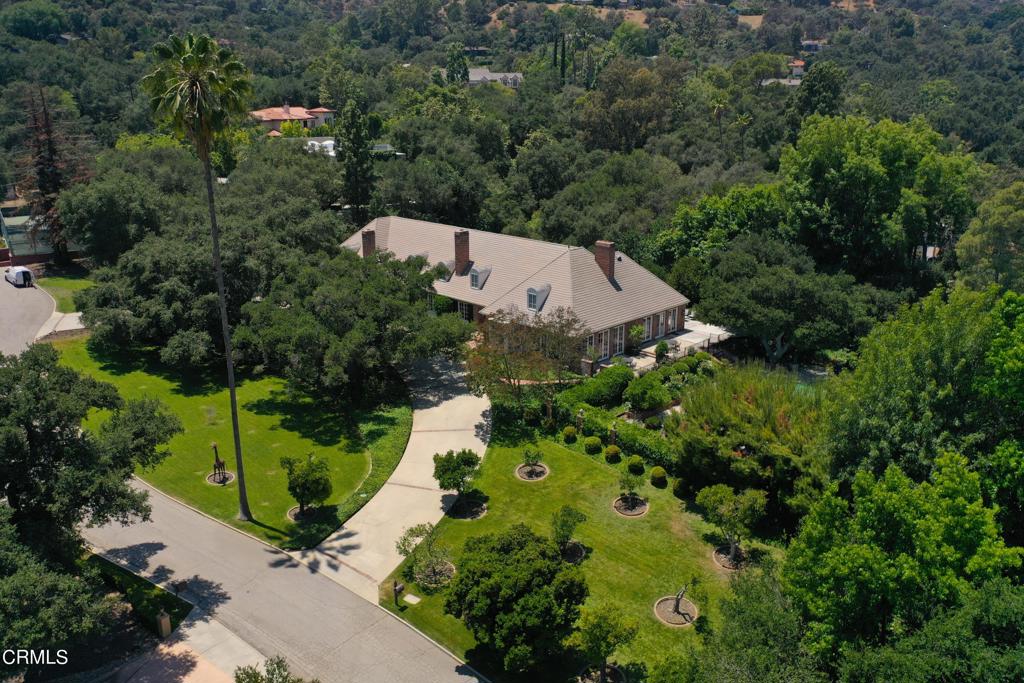 A very unique opportunity to own one of La Canada's finest estates. Welcome to this lovely traditional home situated on over 1.91 acres of park-like manicured grounds. A private, gated residence with a swimming pool, spa, rose garden, beautiful oak trees, and numerous fruit trees. The main residence is over 4,800 square feet (taped). New interior/exterior paint and carpet. Beautiful, refinished parquet flooring. A three car garage with workshop, and a very large attic perfect for remodeling, or a great opportunity for an addition to the residence. There is a well appointed primary bedroom with fireplace, stunning views of the San Gabriel mountains, great room/family room with a built- in bar, generous size bedrooms, maid's quarters, and a formal living room. This home also has a beautiful library with fireplace and a magnificent dining room with views of the exquisite property. This lovely residence is a rare jewel, and a true entertainer's delight!