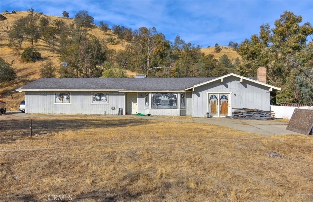 Don't let this remarkable opportunity slip away! Own nearly 5 acres of sprawling land, as documented by tax records. The main dwelling, spanning approximately 1,512 sq ft (buyer advised to verify with tax records), features 2 bedrooms, 2 bathrooms, a detached garage, and an inviting open floor plan. The secondary residence, boasting around 1,764 sq ft (buyer to confirm with tax records), comprises 3 bedrooms, 2.5 bathrooms, and an expansive garage complete with a full bathroom and laundry hookups. Each residence comes with its own address, ( total of 2 addresses only 1 APN ) presenting an enticing prospect for expanding your investment portfolio. While the second dwelling may need some attention (TLC), both homes are served by separate wells and septic systems, ensuring privacy. A paved driveway conveniently connects the two residences at the center. Seize this one-of-a-kind opportunity to invest in a versatile property!
