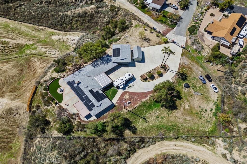 Get out of the city! Own an Estate at the Top of the Hill! Stunning Custom Home with Breathtaking Views! Welcome home to this remarkable, highly desirable Ranch Style residence nestled on over 4.5 acres, offering a rare lifestyle surrounded by the natural beauty of San Jacinto Mountains & Hemet Valley. This move-in ready home seamlessly blends comfort, luxury, & functionality, making it an entertainer’s dream & the perfect family sanctuary. Enjoy 4 bedrooms and 2.5 baths, including an oversized primary suite featuring an en-suite bathroom & a cedar-lined walk-in closet with abundant storage. There is pleanty of room if you want to have your own CHICKENS or perhaps goats. Expansive Kitchen it boasts double ovens, dual sinks, a gas stovetop, ample cabinets & a walk-in pantry. Ideal for social gatherings. Adjoining dining room & living room invite relaxation & connection.
Discover a backyard oasis complete w/ a gas fireplace & mesmerizing views, perfect for evening entertaining or peaceful gatherings in nature.
A separate entry leads to the fourth bedroom, ideal for use as an office or guest suite, catering to your family's varied needs. Stay comfortable year-round with central heating & air conditioning. The home features energy-efficient solar panels & new roofing, reducing electric costs. Indulge in movie nights with a built-in home theater system equipped with Dolby Atmos surround sound—a true cinematic experience at home.
This property includes an RV garage with a full hook-up, 50 AMP outlet, & septic access, providing everything you need for your toys. More perks include a whole-house water filtration system and extra storage. Enjoy Piece of Mind & Safety with a private entry, a remote electric gate, & a home security network equipped with surveillance. The beautifully landscaped gardens feature fruit trees & an oversized driveway for ample parking. Front and Rear Patios. The lower-level property is graded for an Accessory Dwelling Unit (ADU), presenting potential for expansion or rental income.
This exquisite property at 300 Anderson Drive is more than just a home; it’s a lifestyle retreat where every detail has been thoughtfully crafted. Don’t miss this rare opportunity to own a piece of paradise in California—where Zippy the Zebra can be your charming neighbor!
Experience the perfect blend of privacy, space, and luxury living—schedule your private tour today and envision a future filled with enchanting moments in this spectacular residence!