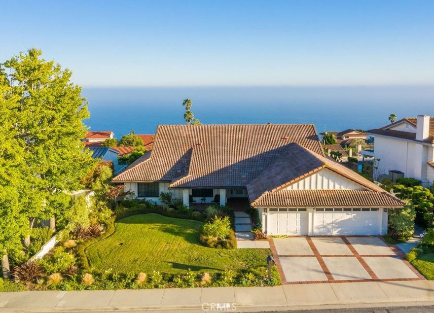 With stunning ocean and Catalina views, this peaceful home located on a quiet and desirable street, exudes warmth and casual elegance. Every detail of this designer 1-level home is well thought-out from the moment you step into the gracious entry, grab a cappuccino in the gourmet kitchen, dine with friends in the formal dining room, or simply sit outside on the romantic patio and enjoy the amazing Southern California sunsets. Feel welcomed by the spacious living room with soaring ceilings, recessed lighting, lush oak plank flooring, and crackling dual fireplace facing both the living room and the kitchen. Enjoy cooking in the completely remodeled kitchen with custom soft-close cabinetry, gleaming Carrera marble counters and top of the line appliances. This family-friendly, open floor plan also offers a den or playroom for the kids adjacent to the kitchen, dining and living areas. A separate laundry room adds to the functional features of this home. The primary suite includes ocean views, walk-in closet, and an oversized bathroom with a soaking tub, spacious shower and two sinks. The remaining three bedrooms are flooded with light and warmth. The three-car drywalled garage with epoxy flooring and storage has power to receive an electric charger. AC, LED lighting, new water heater, and water filtration system are added features that make this home uniquely special and ready to move in before the holidays and make it your dream home. Award-winning schools, hiking trails, Terranea Resort, Golden Cove shops and dining, Portuguese Bend Club, are all added amenities to this remarkably extraordinary slice of heaven.